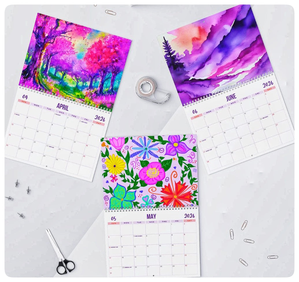 Colorful calendar pages with artistic designs on a white surface.