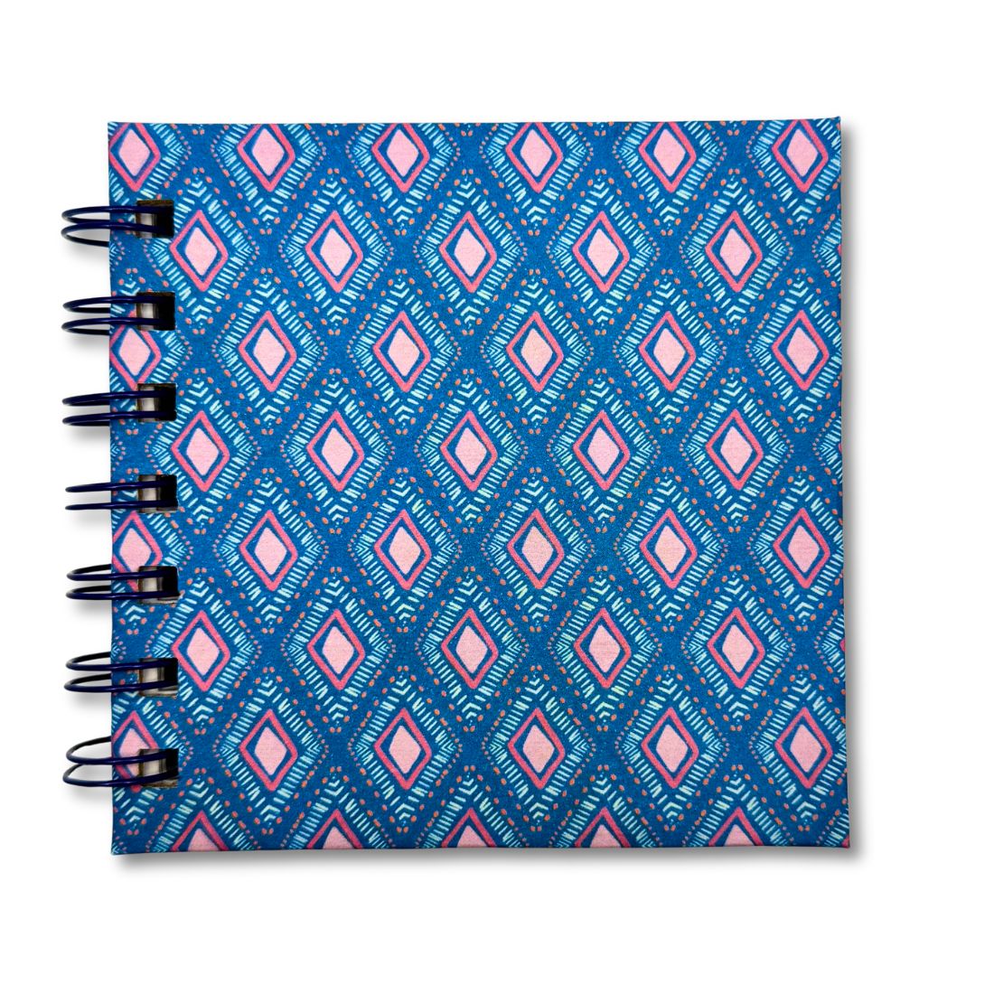 Notebook with blue and pink geometric pattern on a white background