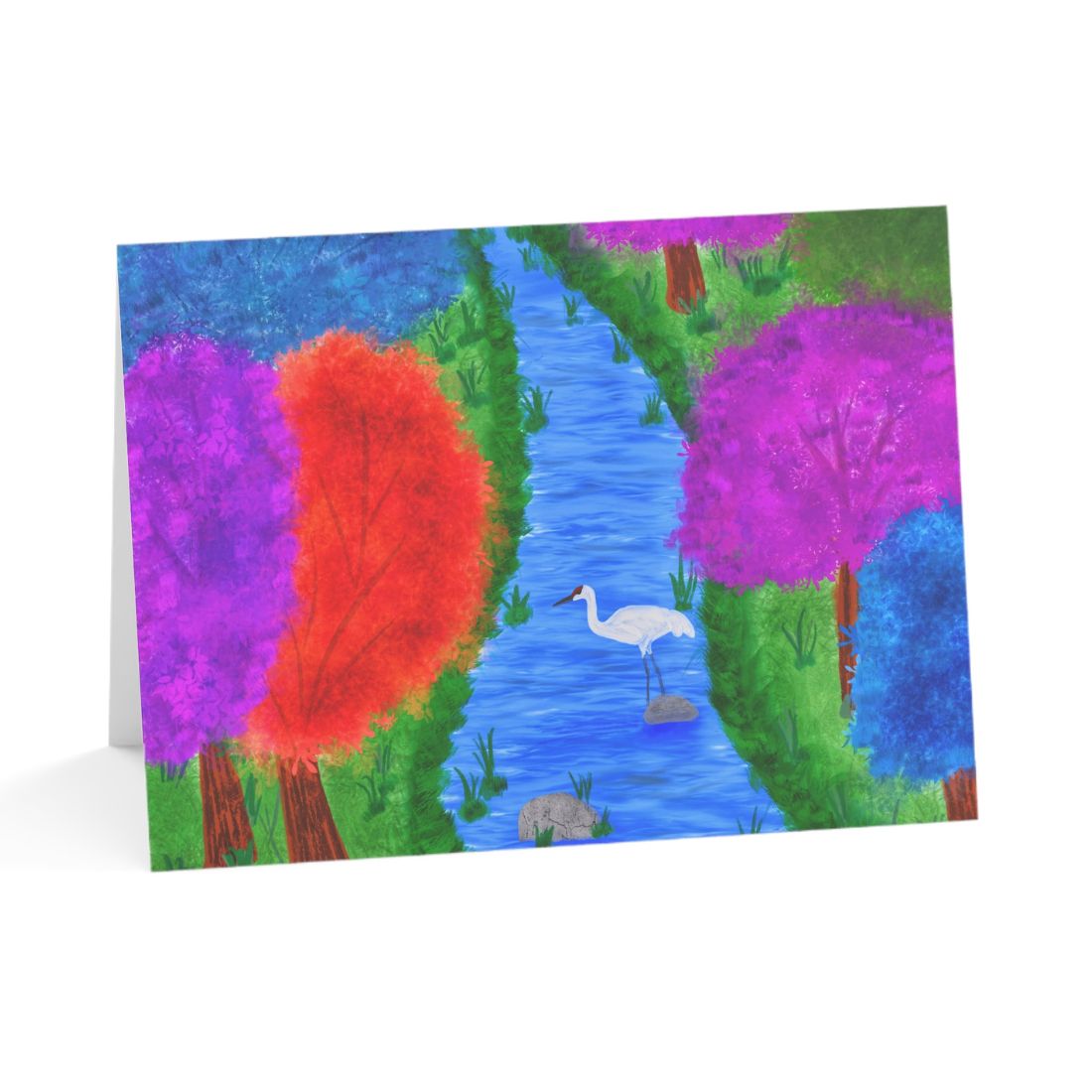 Love To Scribble greeting card showing a white crane in a blue river surrounded by vibrant purple, pink, orange, and blue forest trees.