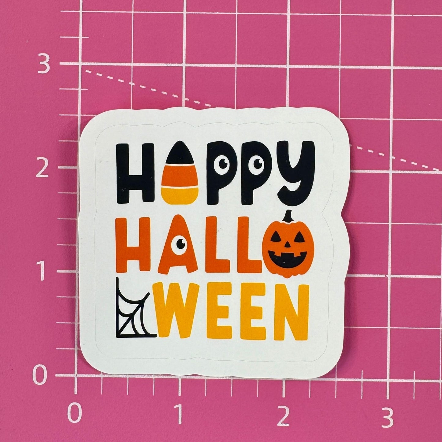 Halloween-themed sticker with 'Happy Halloween' text on a pink grid background