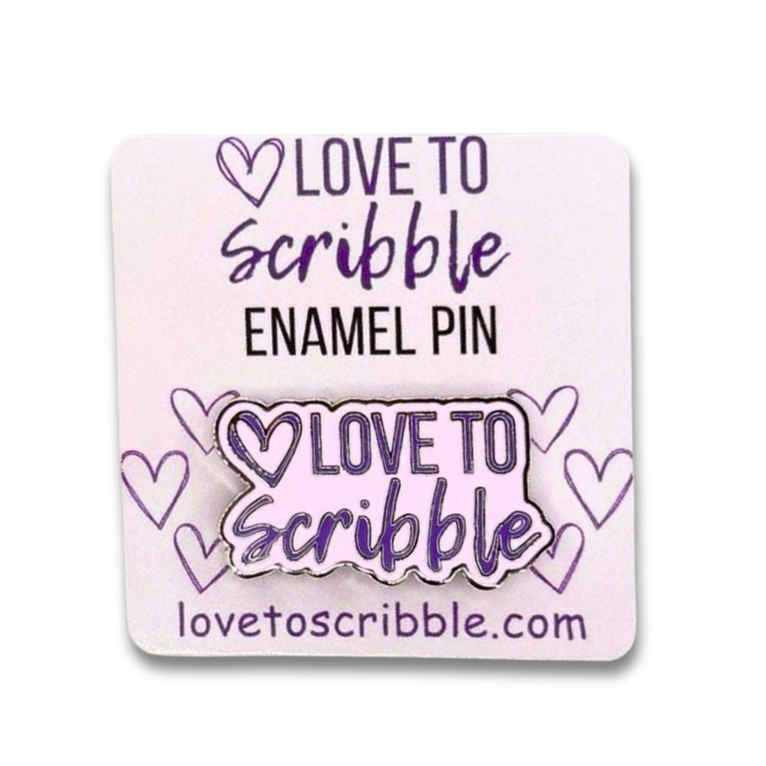 Enamel pin with 'Love to Scribble' text and website on a pink background