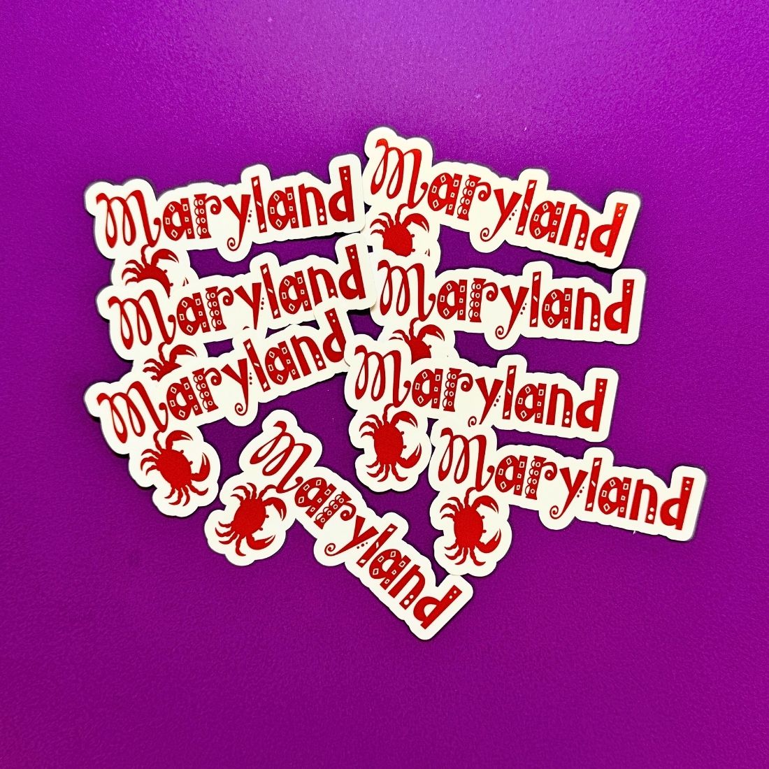 Red 'Maryland' text stickers on a purple background