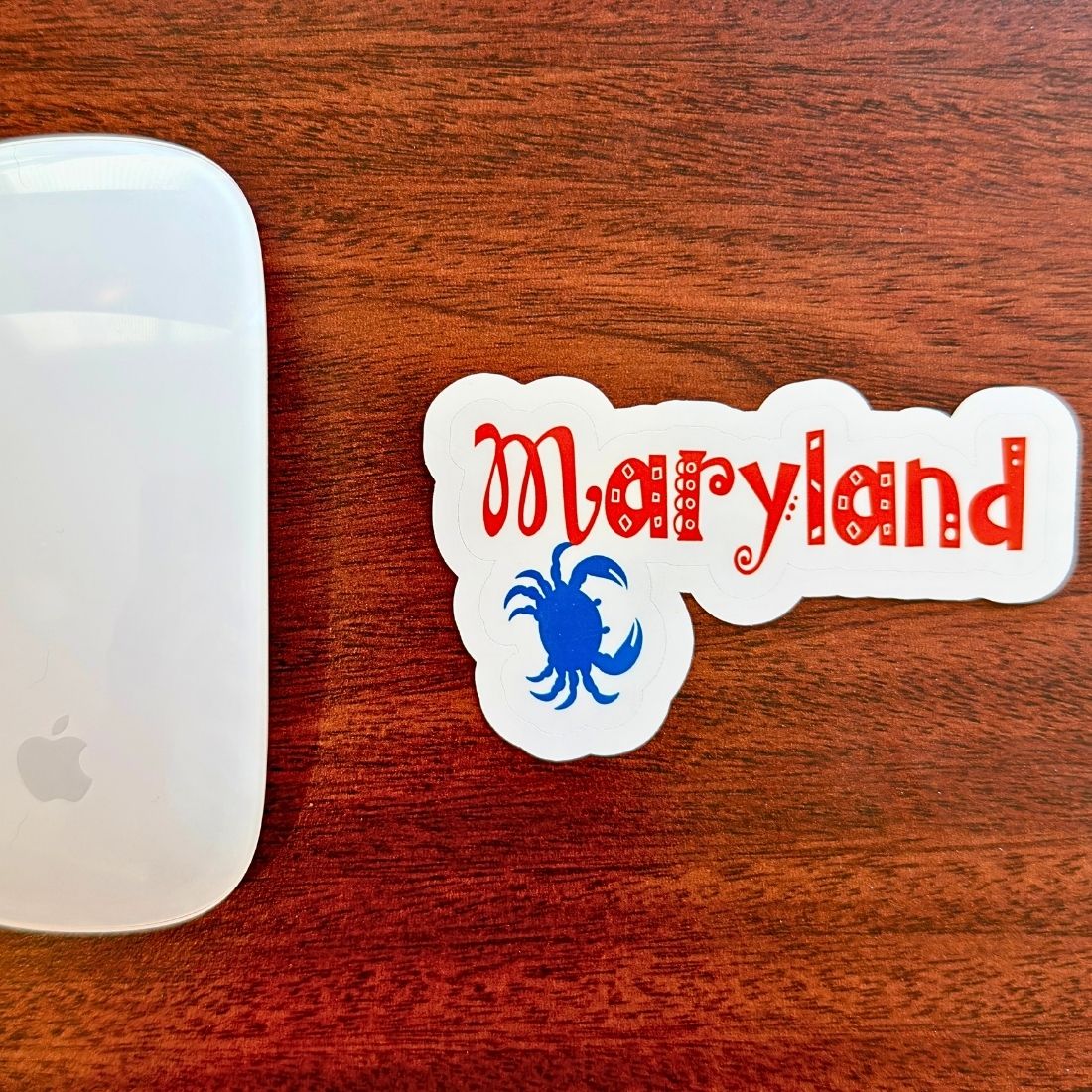 Maryland crab vinyl sticker displayed beside a computer mouse
