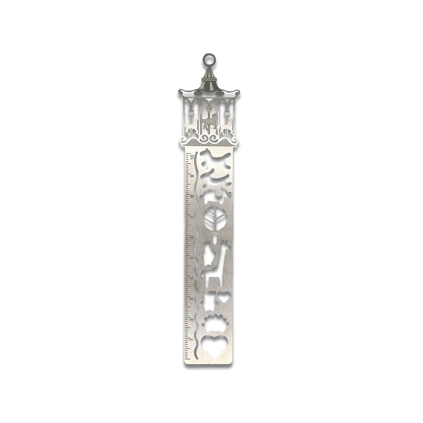 Decorative merry-go-round metal ruler bookmark with intricate designs on a white background