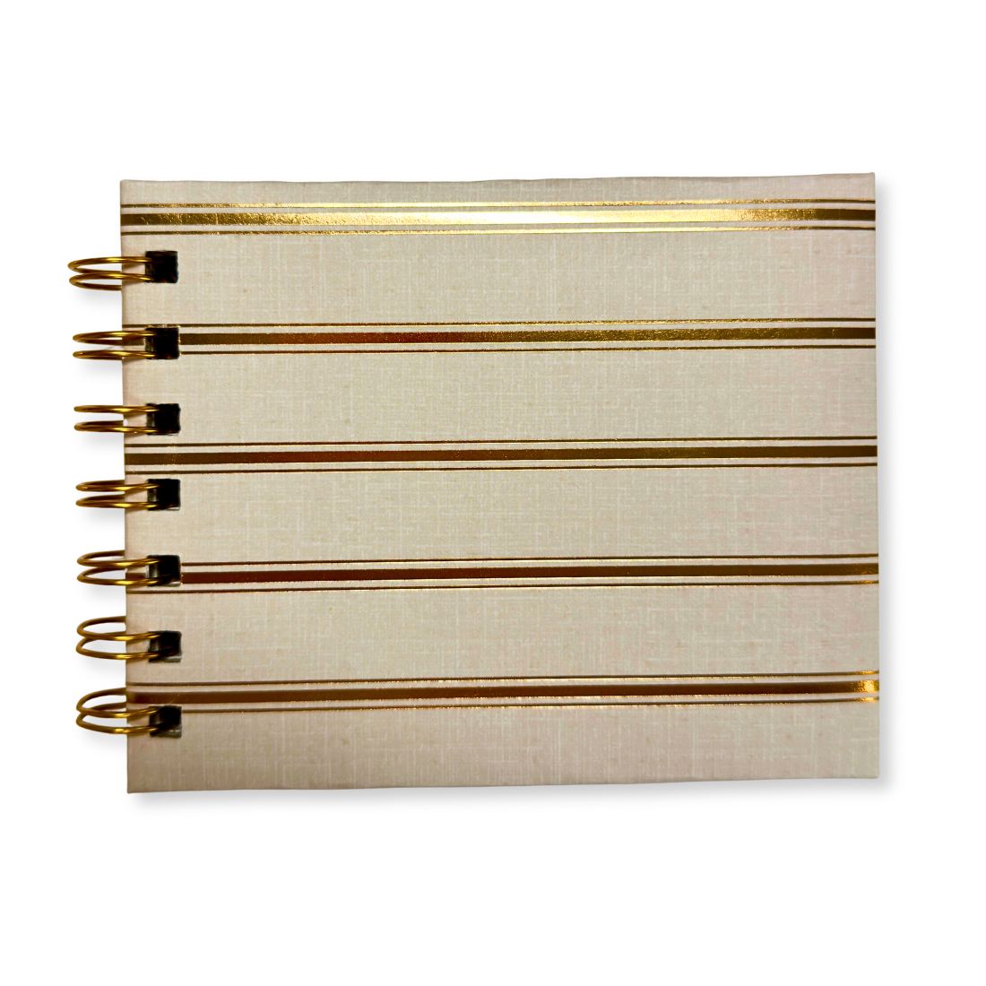 Front view of Love To Scribble mini notebook featuring horizontal metallic gold stripes on a cream hardcover with gold spiral binding.