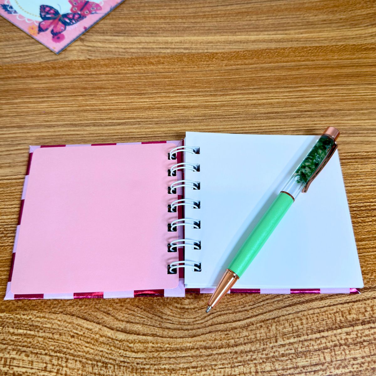 Compact pink spiral notebook with blank pages