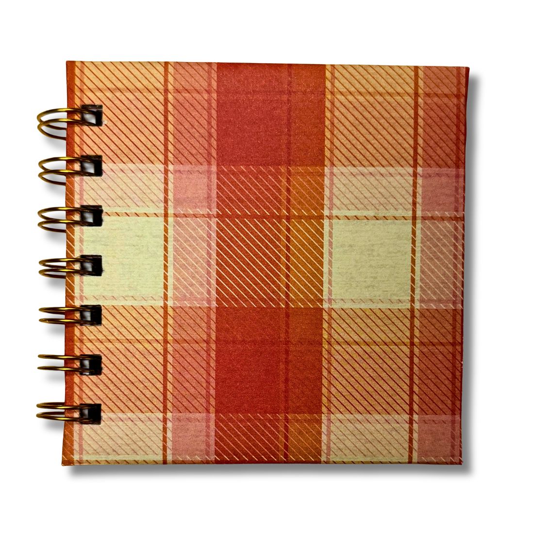Plaid notebook with spiral binding on a white background