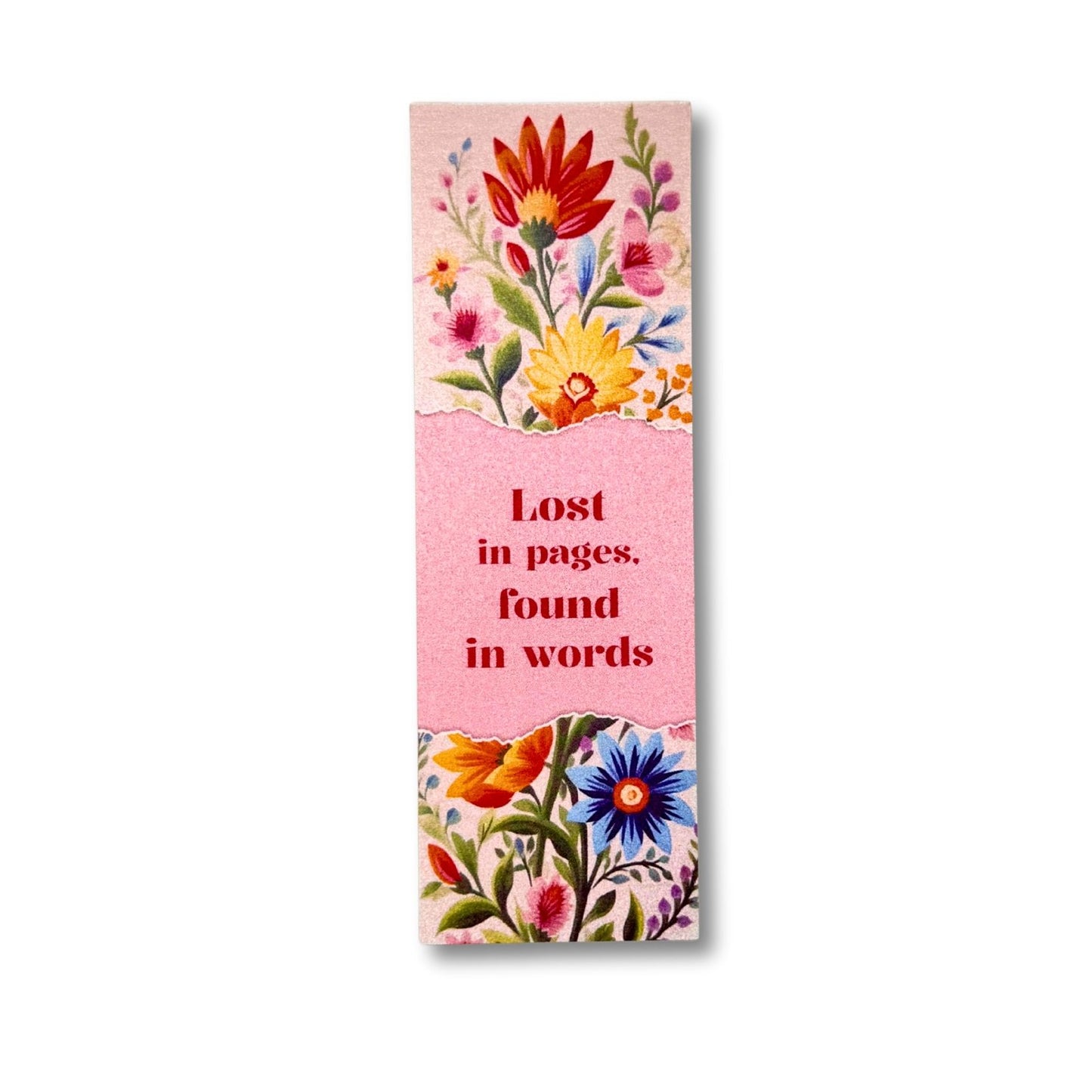 Floral bookmark with text 'Lost in pages, found in words' on a pink background
