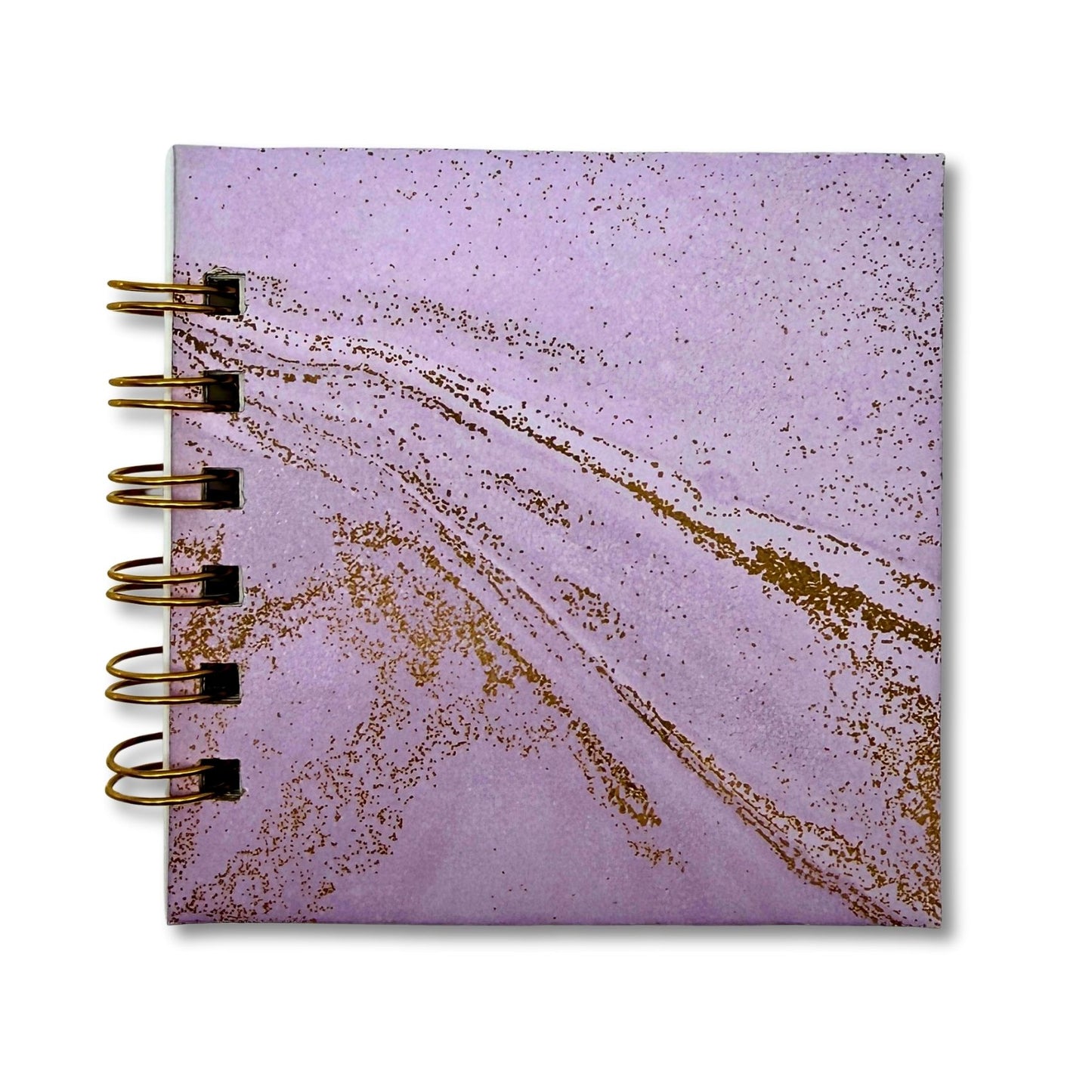 Purple notebook with gold swirl abstract design on a white background