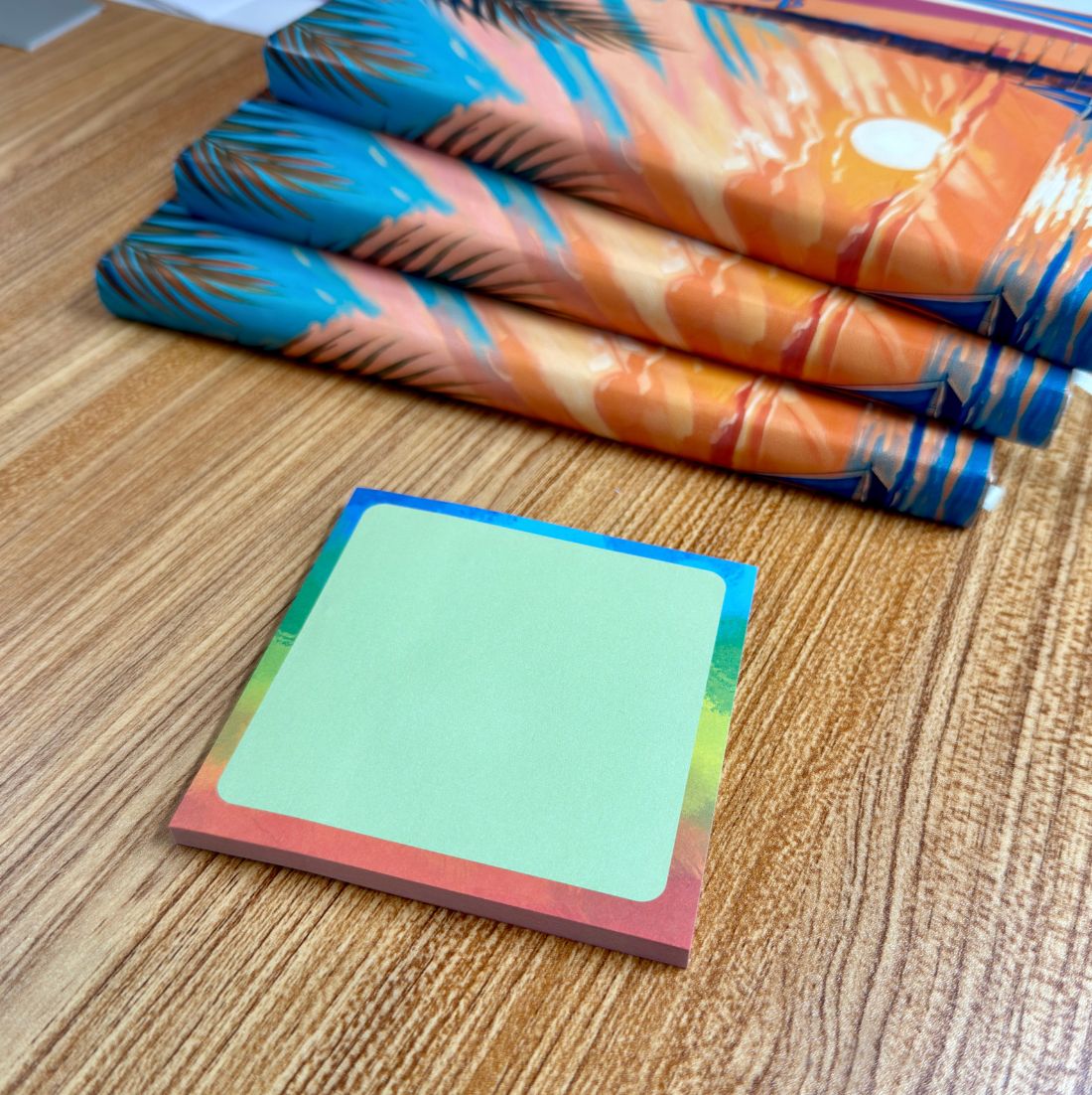 Rainbow Watercolor sticky notes displayed on a wooden desk