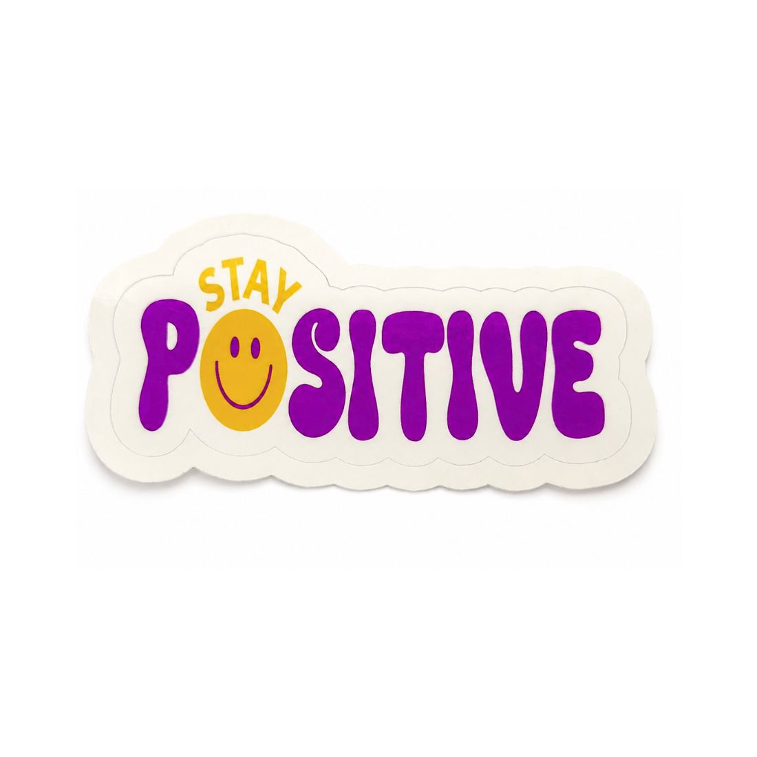 A die-cut sticker with the words 'STAY POSITIVE' in purple and yellow, featuring a yellow smiley face replacing the letter O, on a white background.