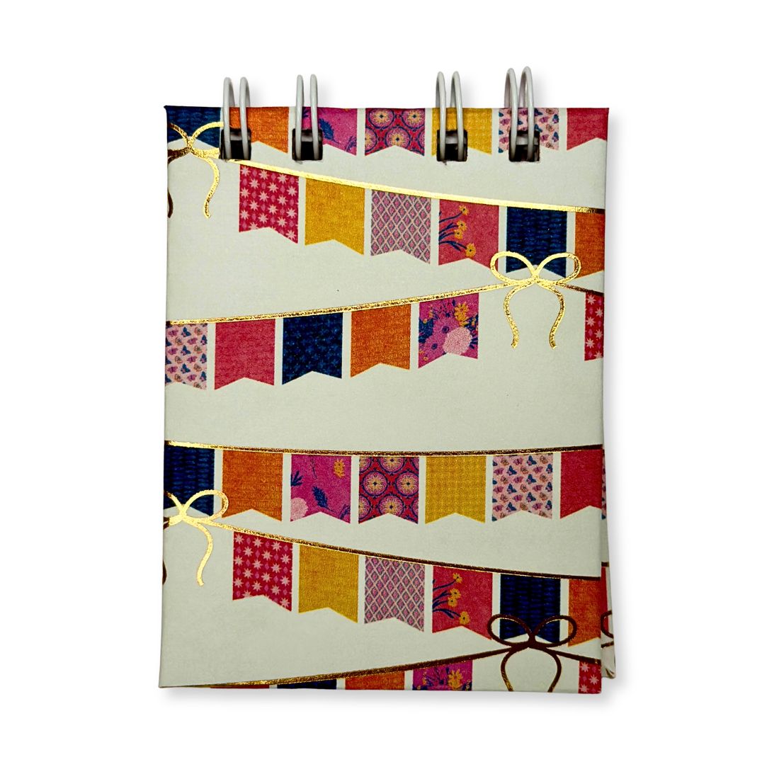 Front cover view of the Love To Scribble White Extra Mini Notebook showing rows of colorful festive flags and shimmering gold foil bows with a white wire binding at the top.