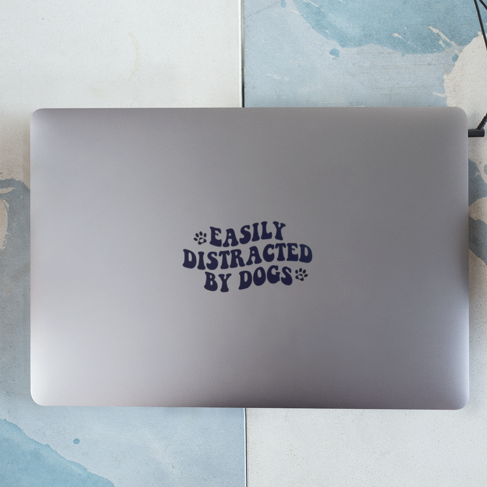 
                  
                    Easily Distracted By Dogs Decal Sticker on Laptop on table
                  
                